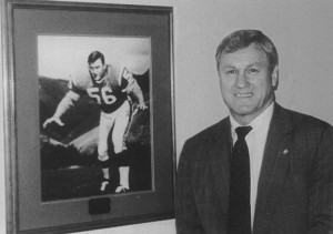 "Bull" standing by his picture on the Denver Broncos Wall of Fame at the Denver Broncos Complex.